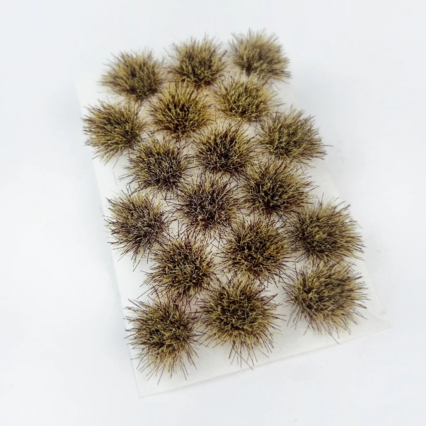 Dry brown round self-adhesive static grass tuft sheet, miniature dead foliage clumps for wasteland wargame bases, autumn diorama landscape and scale model railroad scenery craft, natural dry earth tone mini grass clusters