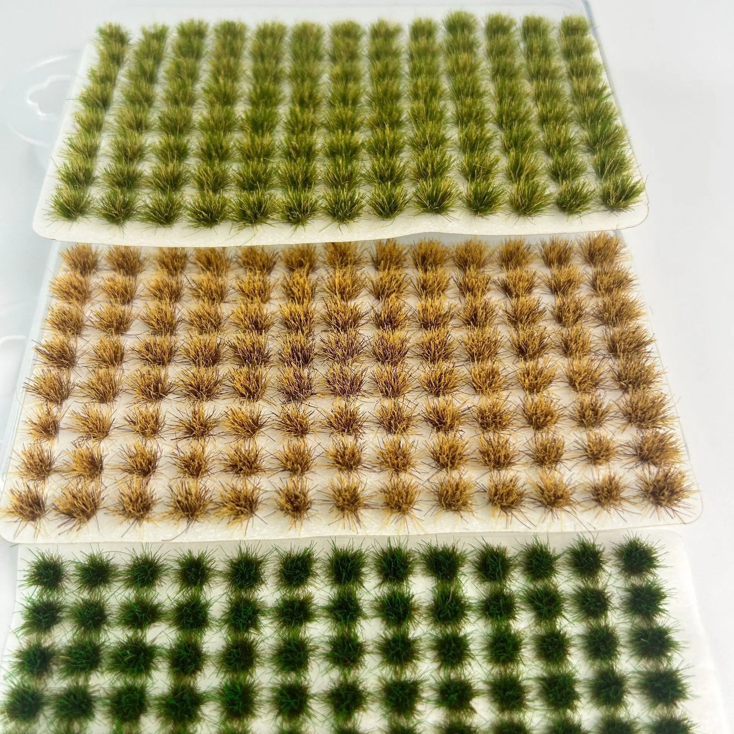 Pack of 104 self-adhesive static grass tufts sheet, 10.8cmx6cm overall size with bright lush green mini foliage clumps, close-up detail display, static grass tufts, miniature diorama supplies, wargame terrain material, model railway grass, self-adhesive grass clusters, scale model scenery, warhammer terrain, hobby craft grass