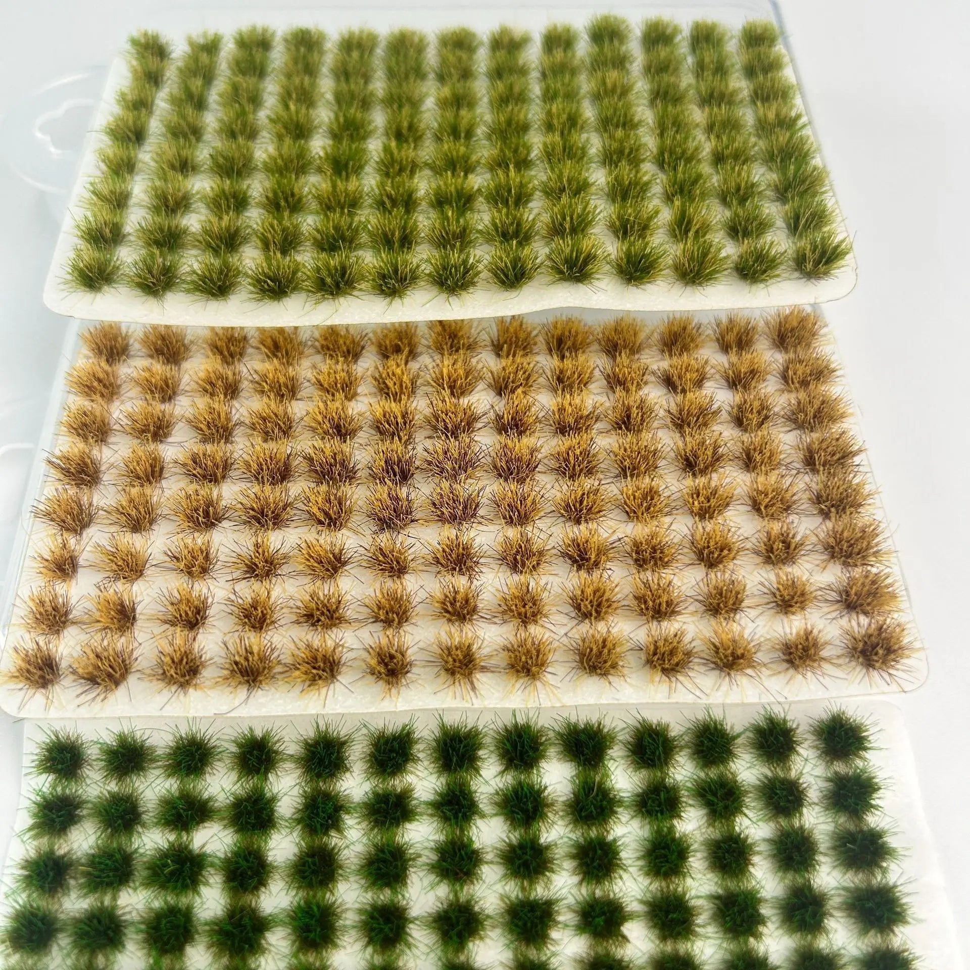 Pack of 104 self-adhesive static grass tufts sheet, 10.8cmx6cm overall size with bright lush green mini foliage clumps, close-up detail display, static grass tufts, miniature diorama supplies, wargame terrain material, model railway grass, self-adhesive grass clusters, scale model scenery, warhammer terrain, hobby craft grass