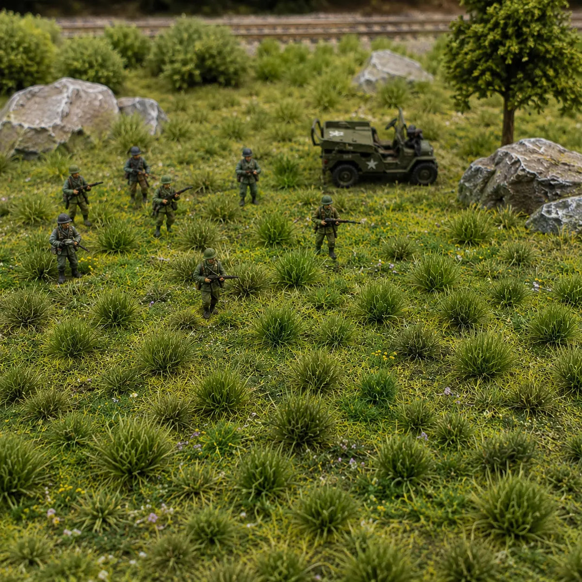 Green grass tufts used on miniature wargaming terrain with soldiers and a military vehicle