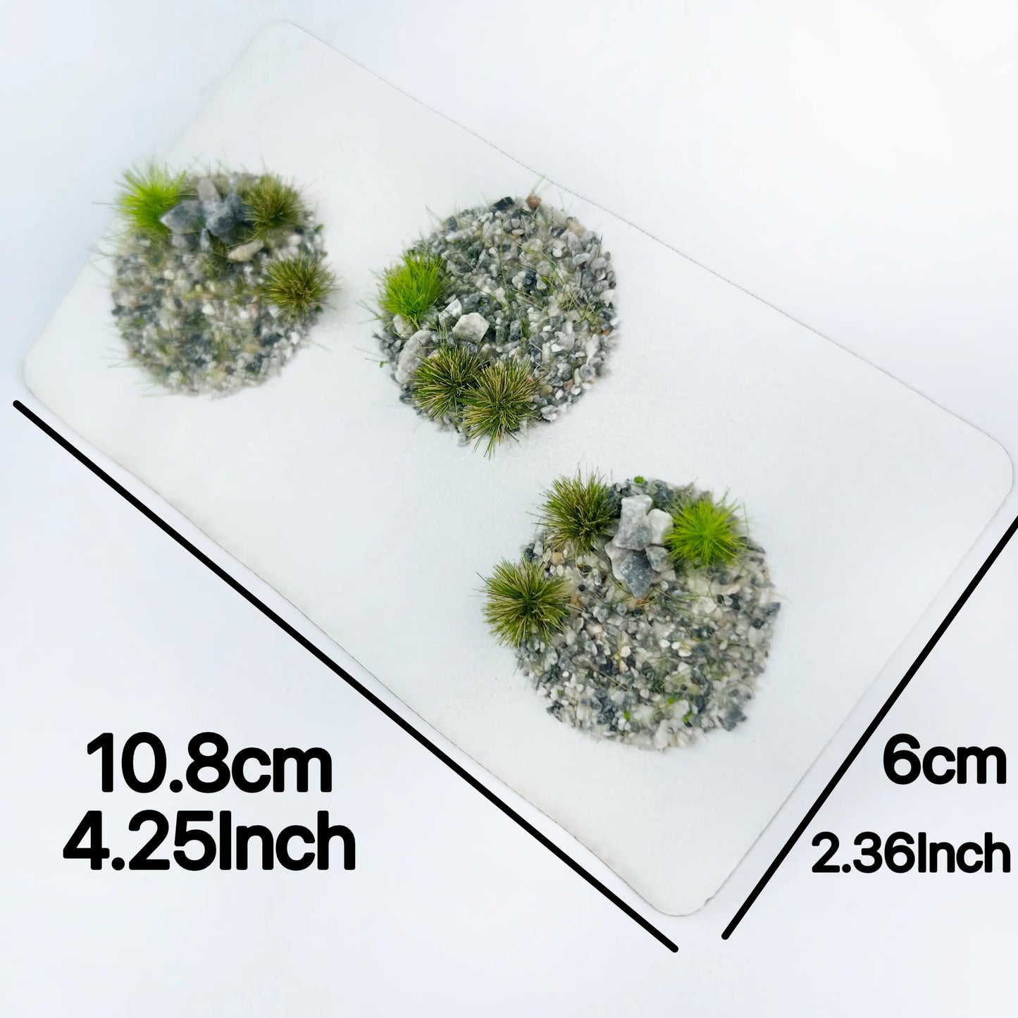 Tweezers peeling self-adhesive gravel rock grass tuft clump, removable rocky miniature foliage sheets for custom DIY wargame base, diorama terrain and scale model scene building