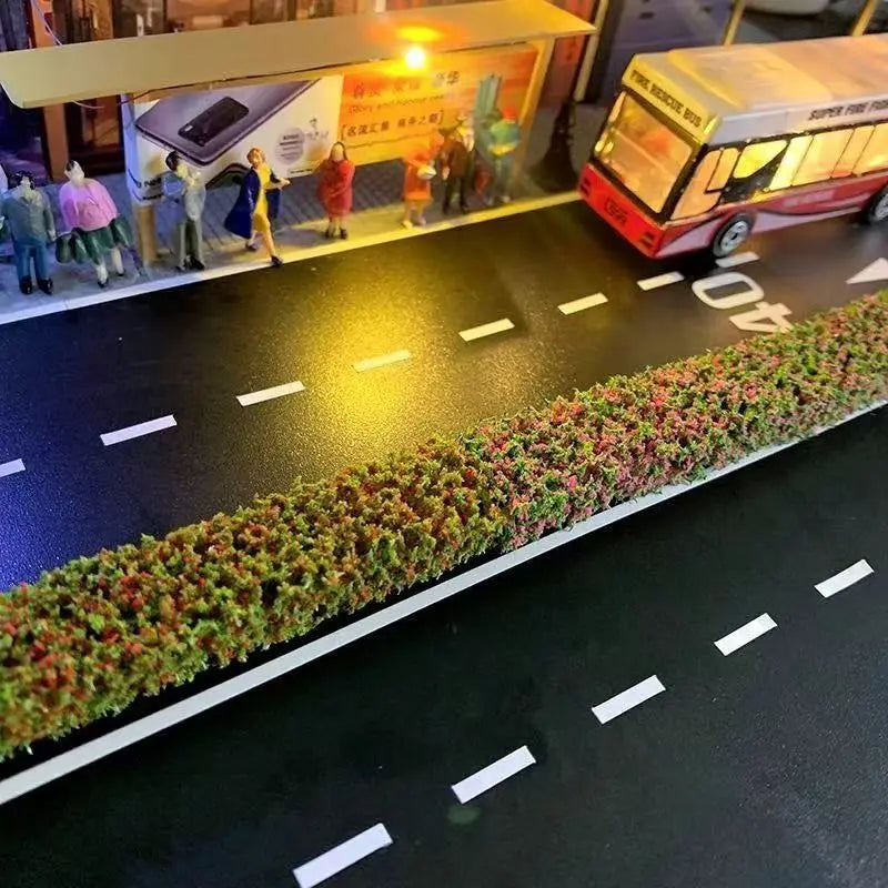 City bus stop diorama layout with colorful flowering miniature hedge strip roadside border
