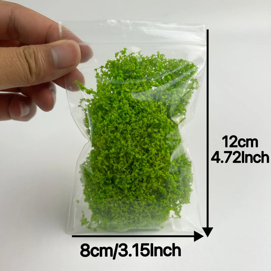 Light green, airy artificial moss clump, lifelike miniature ground cover for diorama making, model railway terrain, and dollhouse landscaping.