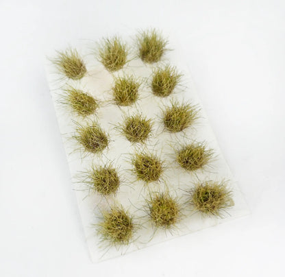 Pre-cut circular static turf tufts, railway scale model scenery, various seasonal grass colors stacked display, high definition product render, no shadows clutter