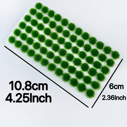 Dimension labeled product photo of vibrant green self-adhesive static grass tuft sheet, marked 10.8cm × 6cm / 4.25inch × 2.36inch, size reference for miniature terrain craft supplies