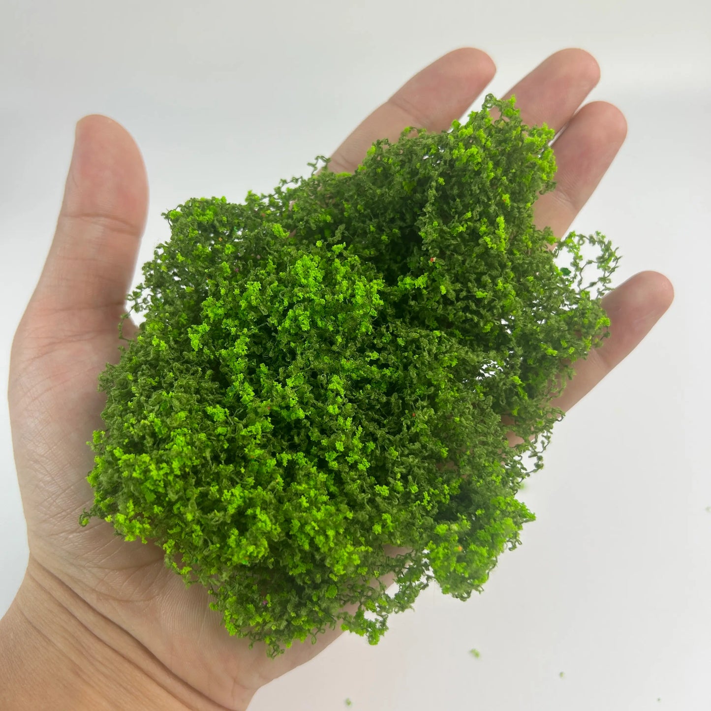 Dark green artificial moss clump with kind reminder text, miniature vegetation for scale model hobby, diorama making, and craft supplies.