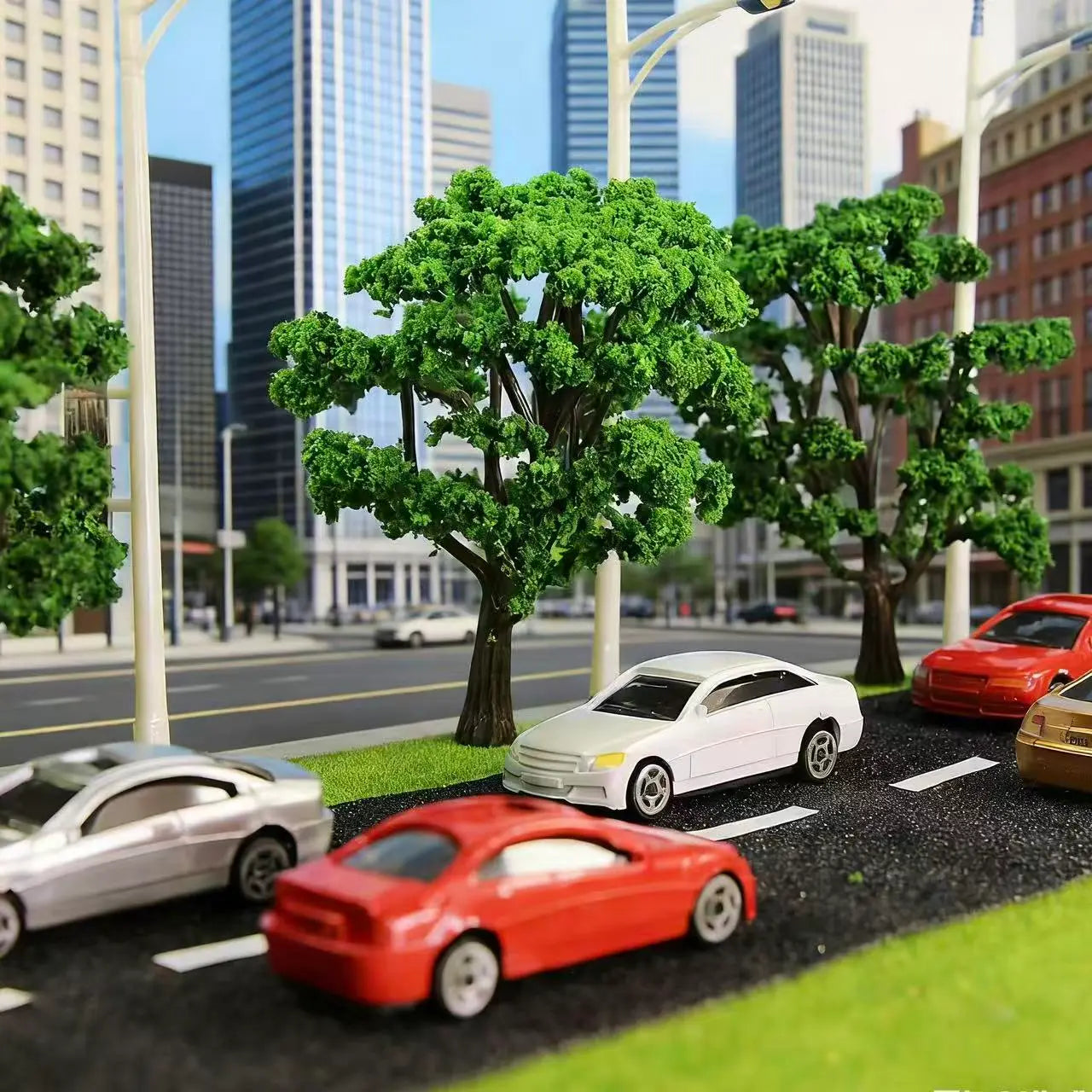Urban city street diorama scenery with green model trees and 1/150 scale mini static car decorations