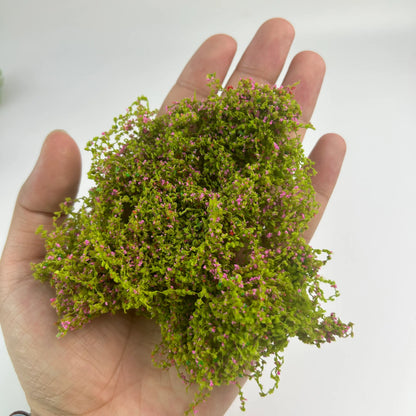 Dark green artificial moss clump with kind reminder text, miniature vegetation for scale model hobby, diorama making, and craft supplies.