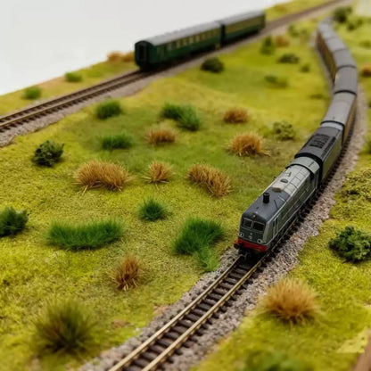 Dark emerald green irregular varied shape static grass tufts with fluffy texture, pre-attached self-stick grass patches, natural wild grass accessory for wargame and countryside railway layout