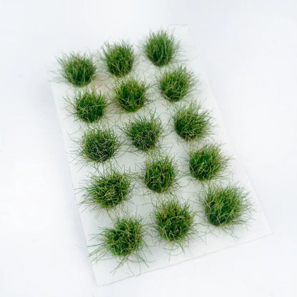  Vibrant olive green mini grass clumps, dollhouse garden terrain material, pre-stuck round tufts, studio product photography, fine realistic grass strands