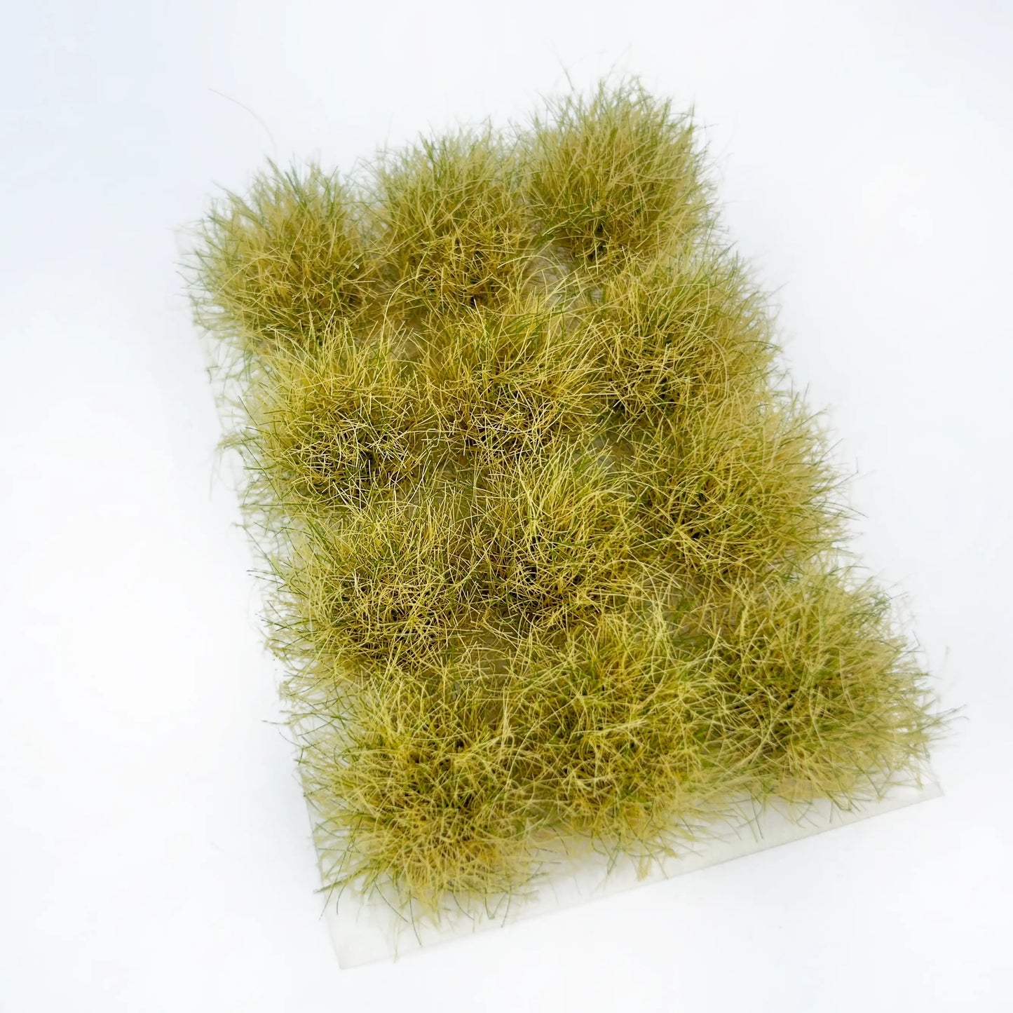 Self-adhesive dry yellowish miniature grass tuft mat with faint green strands, marked with full size measurements for arid wasteland diorama terrain craft reference