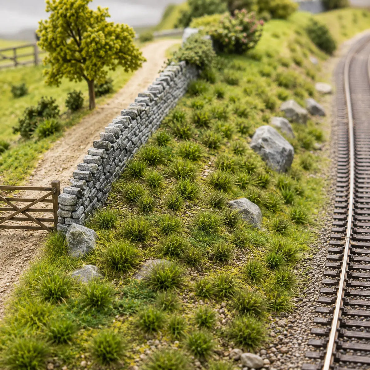 Miniature railway hillside landscaped with realistic green grass tufts