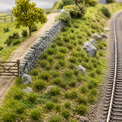 Miniature railway hillside landscaped with realistic green grass tufts
