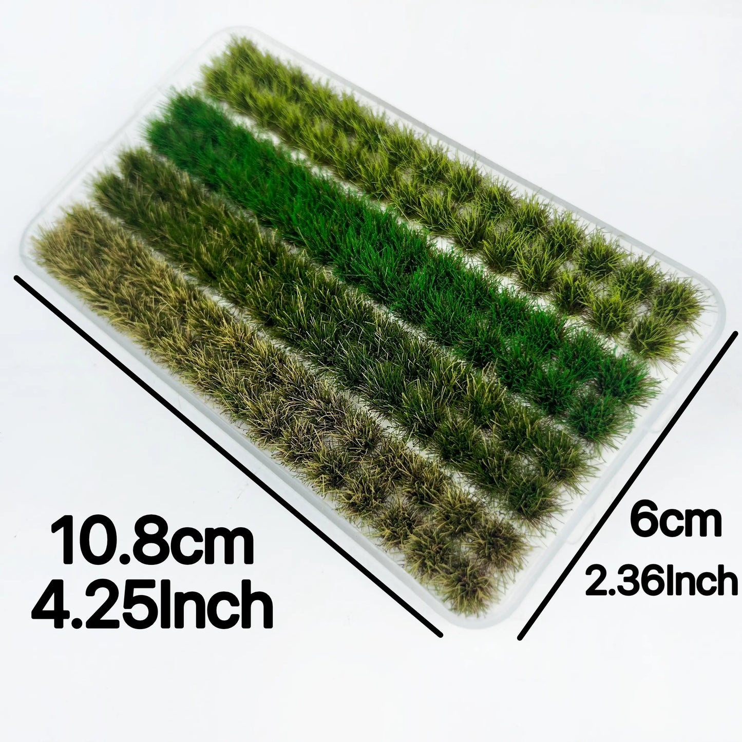 Clear plastic tray with four shades of miniature static grass tuft strips, marked with 10.8cm × 6cm size measurements for diorama wargame terrain craft reference