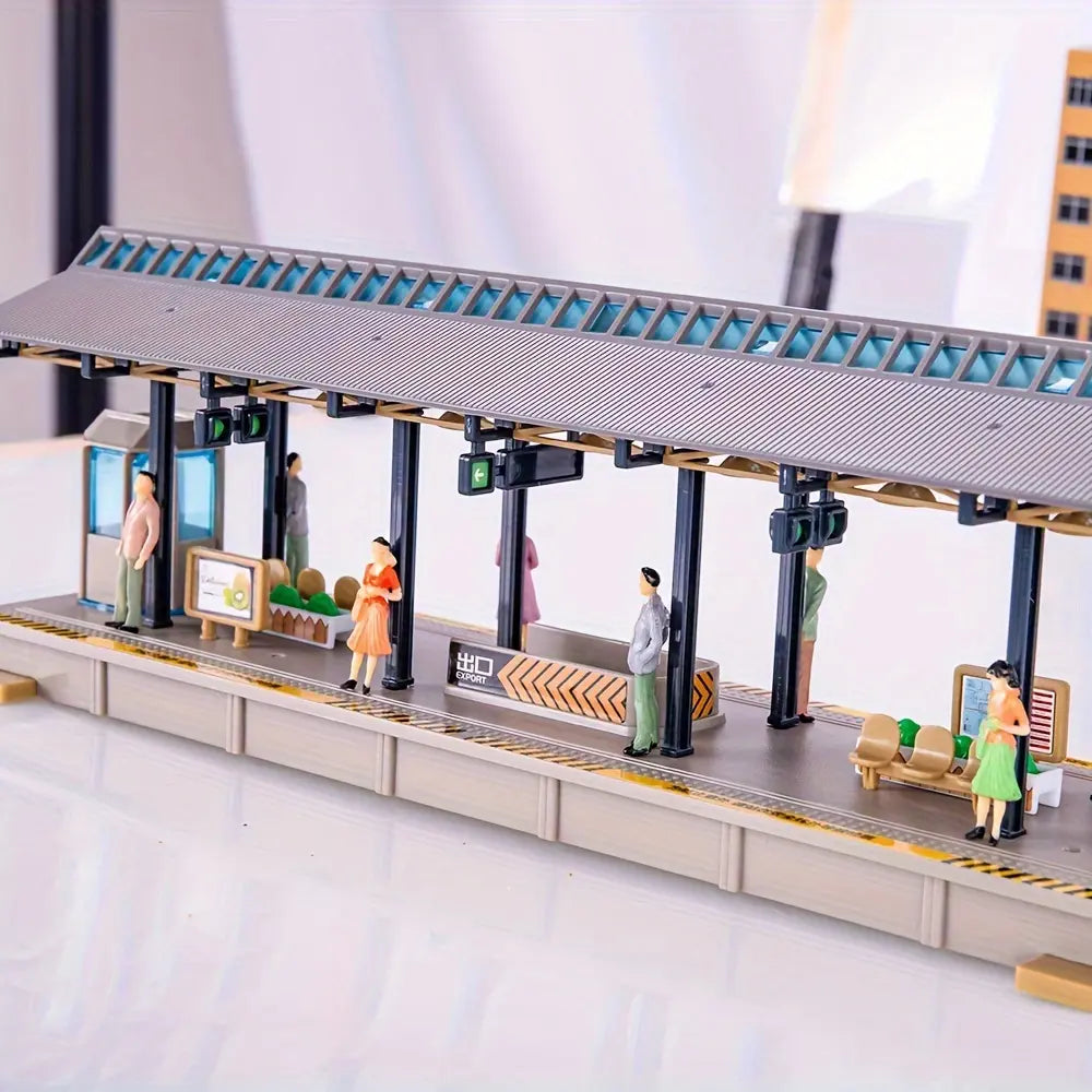 Finished scale model railway station platform diorama layout decorated with colorful miniature people figures, realistic waiting crowd tiny human miniatures for train railway scenery, urban city wargame terrain handmade craft