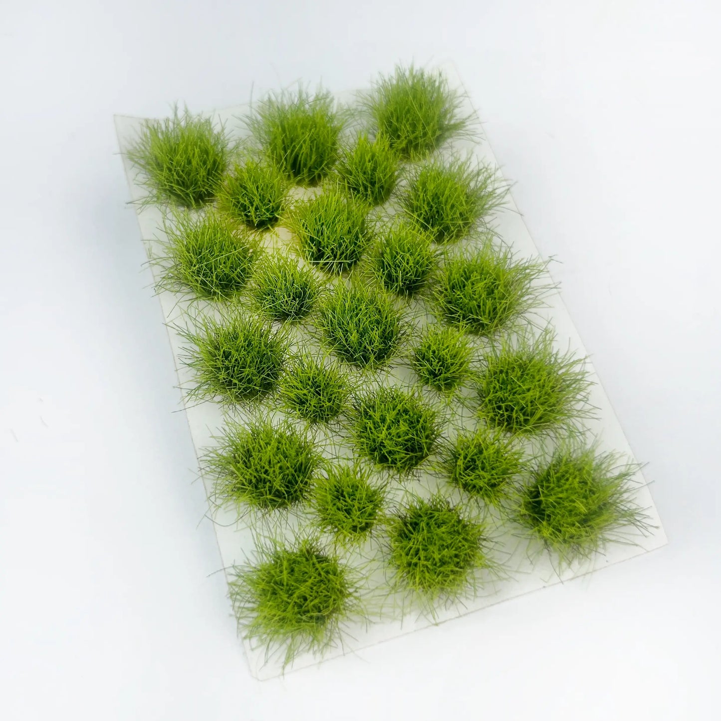 Soft light spring green static grass tuft sheet, pre-placed self-adhesive wild grass clumps, fresh meadow foliage material for scale model diorama, war game terrain, railroad layout hobby craft
