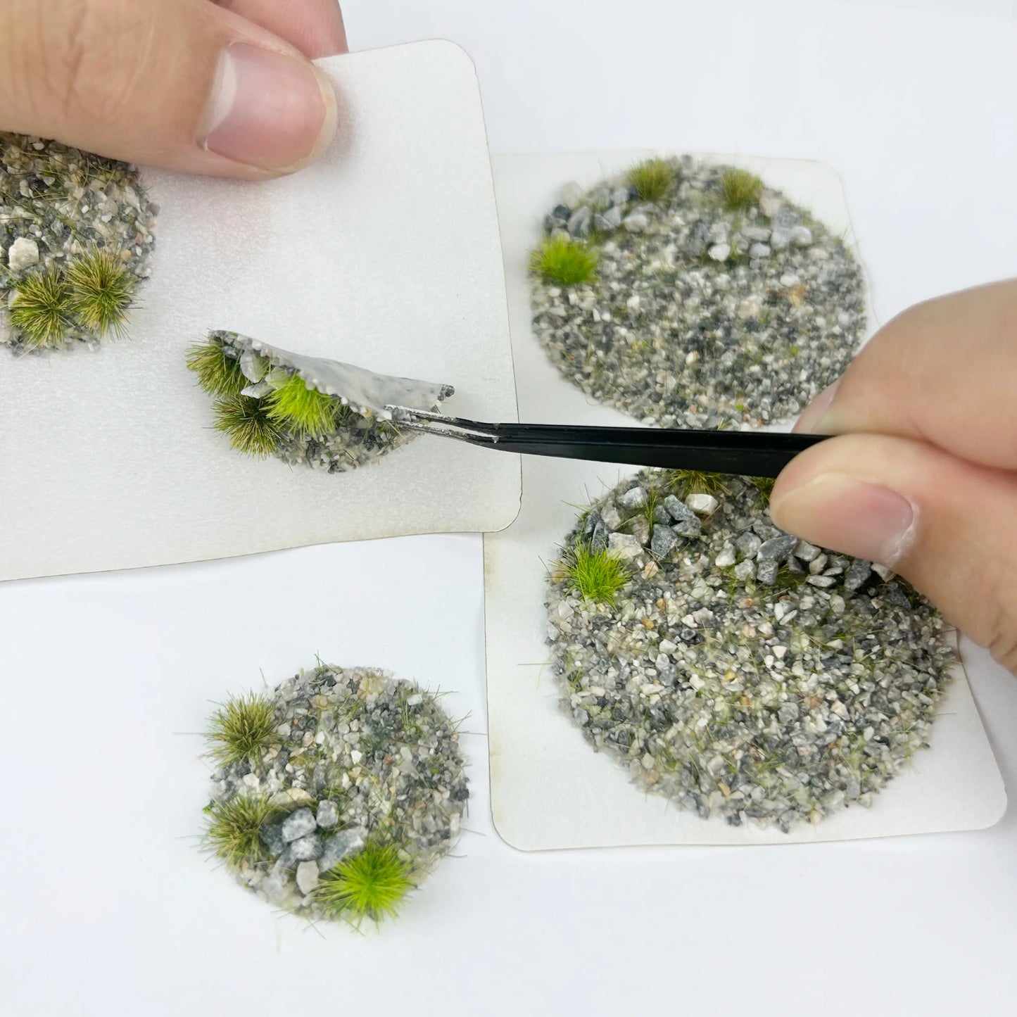 Gravel rocky static grass tuft sheets stacked in clear hanging plastic storage boxes, mixed pebble miniature terrain clumps for wargame base, diorama landscape and scale model railroad scenery crafting
