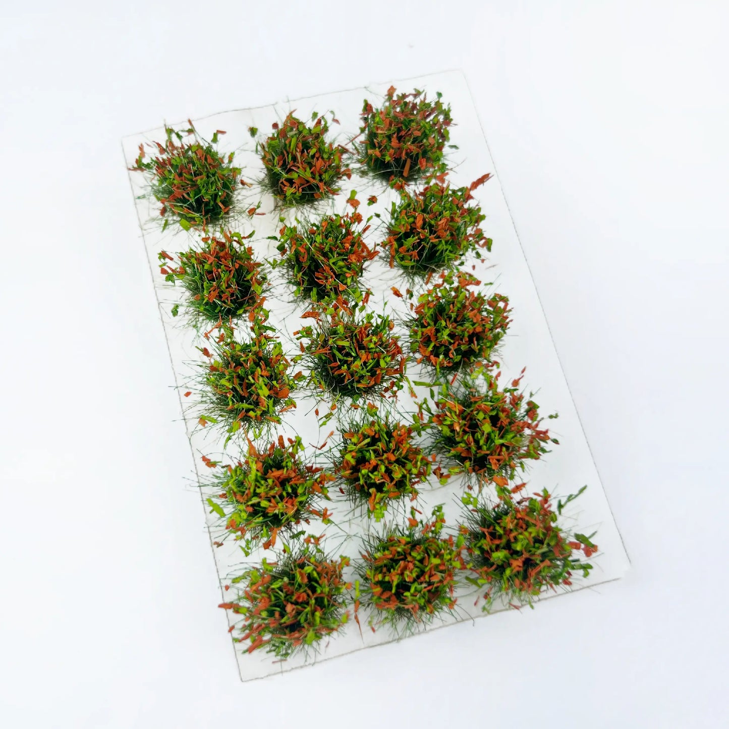 Mixed green and orange seasonal static grass tuft sheet, transitional spring-autumn mini grass clumps for countryside diorama, tabletop game terrain and scale model making
