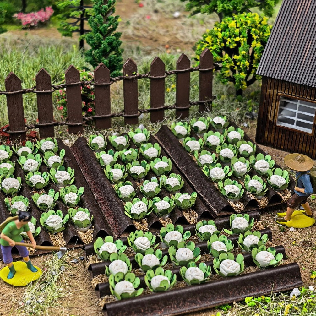 Backyard farm diorama with miniature cabbage crop trays, wooden fence and farmer figure for wargame terrain creation