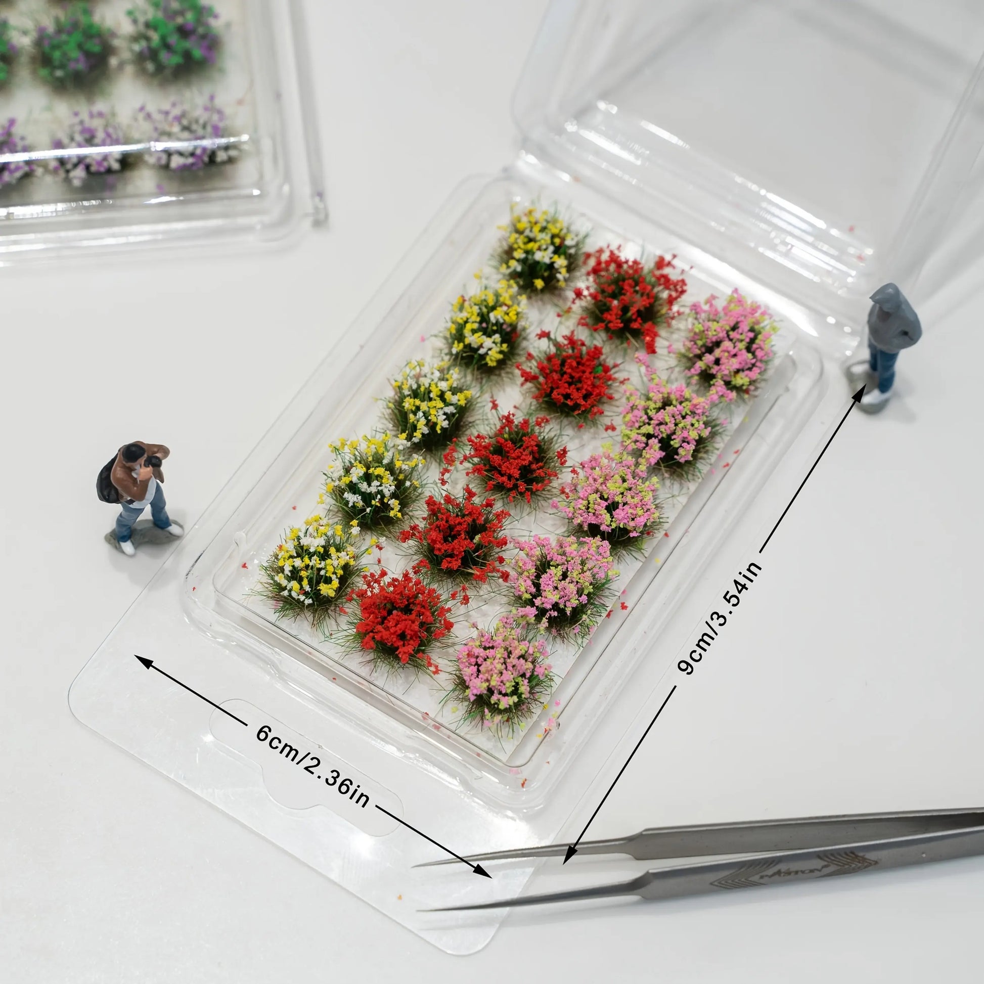 Mixed color miniature self-adhesive flower tufts in clear plastic blister pack, model diorama scenery supplies for wargame and railway layout
