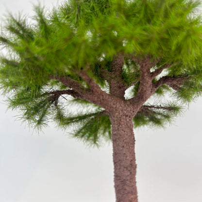 Extreme close-up of fine green pine needle clusters on scale model tree, realistic texture for detailed diorama scene