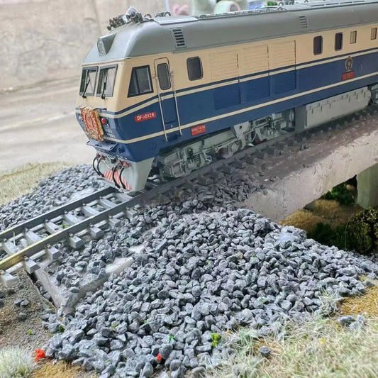 Complete railway layout display with realistic ballast gravel beside train rails