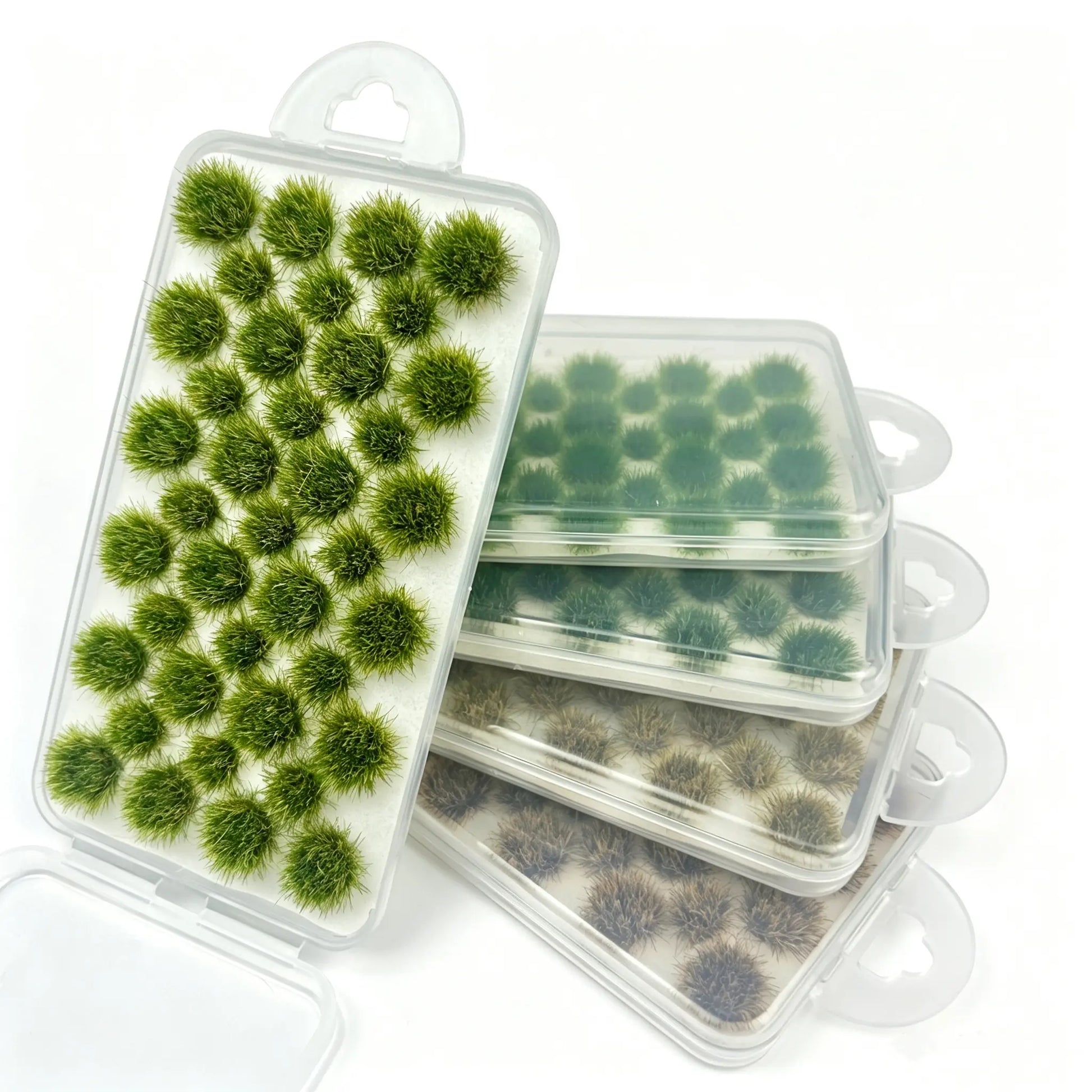 Mixed tone round static grass tuft sheets stacked in clear hanging plastic storage boxes, self-adhesive mini foliage clumps for wargame base, diorama landscape and scale model railroad scenery crafting, bright green, olive and dry brown miniature grass clusters