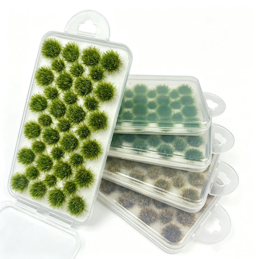 Mixed tone round static grass tuft sheets stacked in clear hanging plastic storage boxes, self-adhesive mini foliage clumps for wargame base, diorama landscape and scale model railroad scenery crafting, bright green, olive and dry brown miniature grass clusters