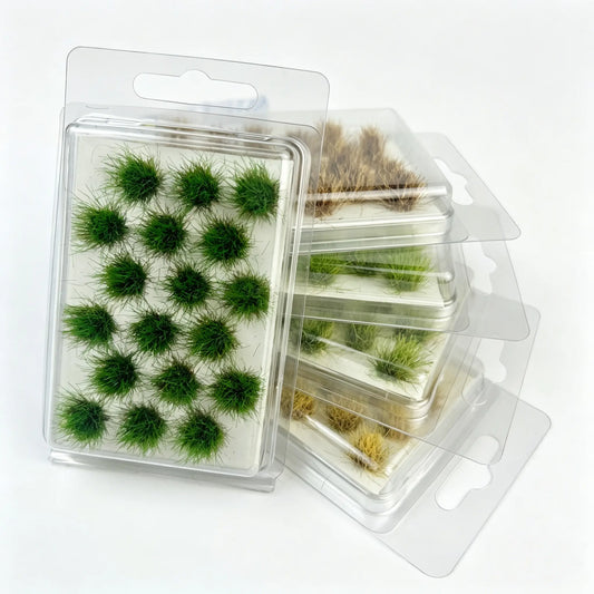 Mixed tone round static grass tuft sheets stacked in clear hanging plastic storage boxes, self-adhesive mini foliage clumps for wargame base, diorama landscape and scale model railroad scenery crafting, bright green, olive and dry brown miniature grass clusters