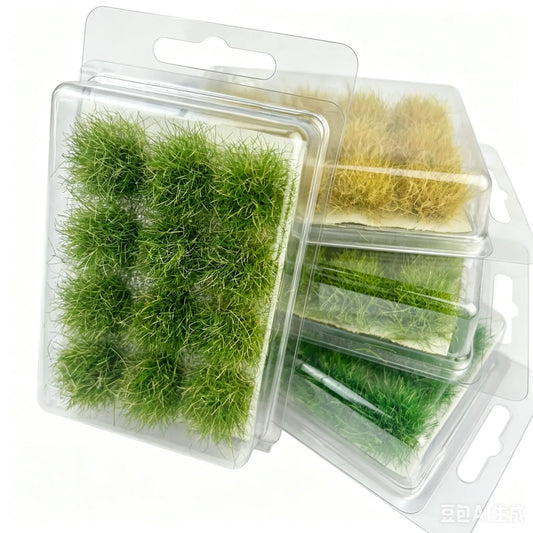 Blister pack box set of pre-made self-adhesive grass tufts, multiple color green and yellow grass cluster kits, packaged hobby terrain material, ready-to-use miniature foliage accessory for diorama, tabletop game and scale model scene making