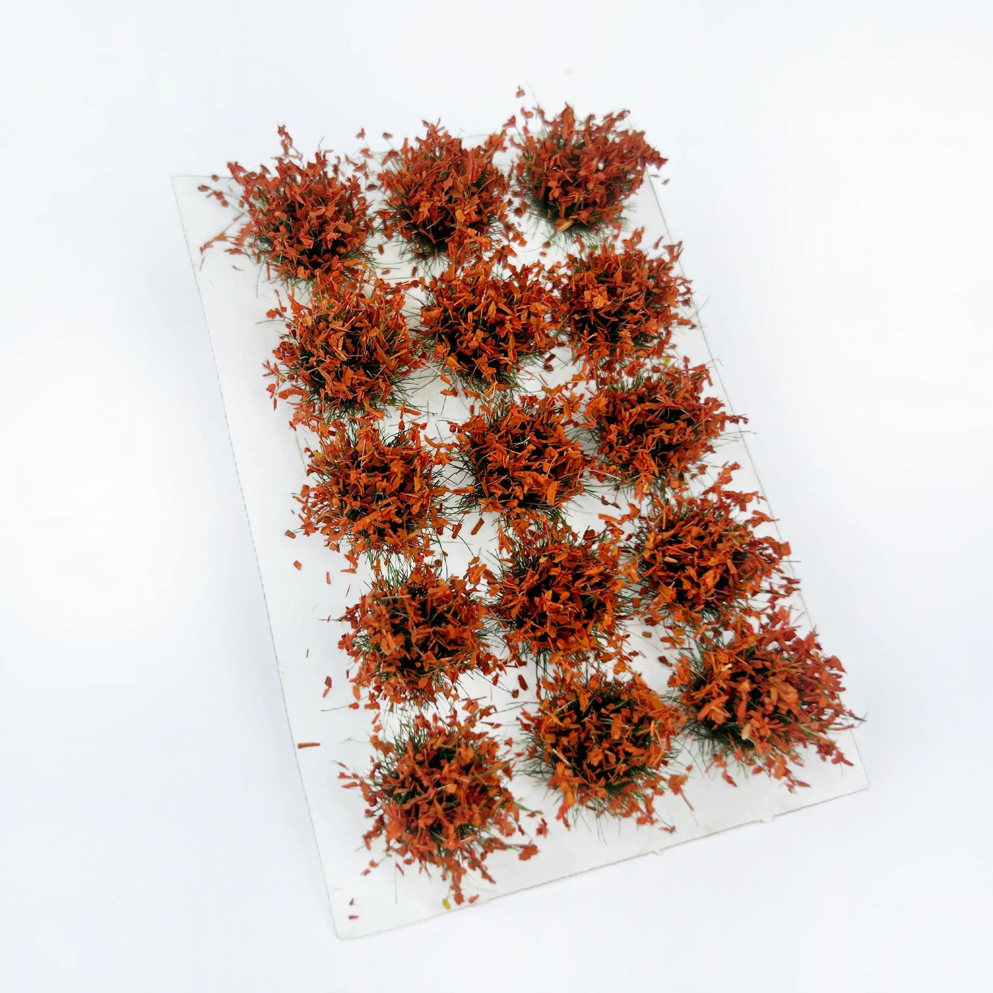Deep rust orange fall static grass tuft sheet, rich warm foliage clumps for forest autumn diorama, historical wargame terrain and miniature building base decoration