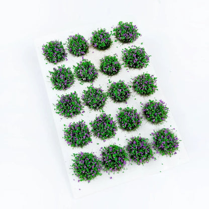 Vibrant green round self-adhesive static grass tuft sheet covered with small purple wild flower clusters, mini shrub foliage clumps for countryside garden diorama, fantasy wargame miniature base and train model scenery decoration
