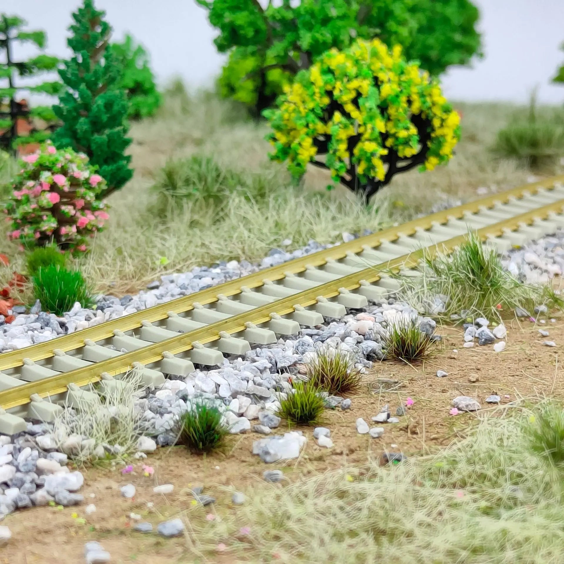 N scale model railway layout scenery decorated with realistic static grass tufts, hobby terrain building supplies