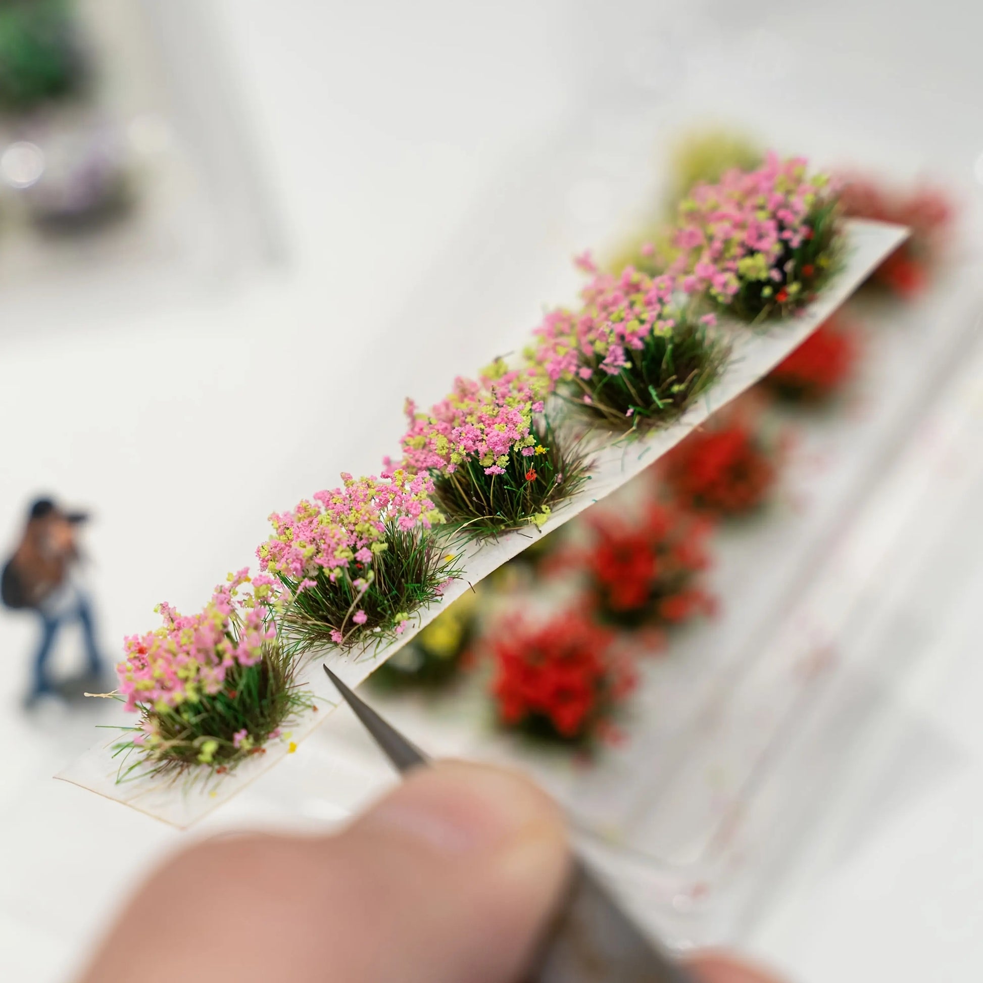 Wooden dollhouse staircase decorated with mini flower tufts and scattered petals for delicate interior scene effect