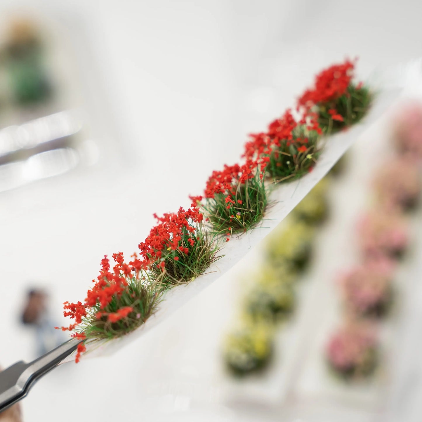 Completed miniature riverside cottage diorama decorated with these flower tufts, creating vivid natural garden scenery