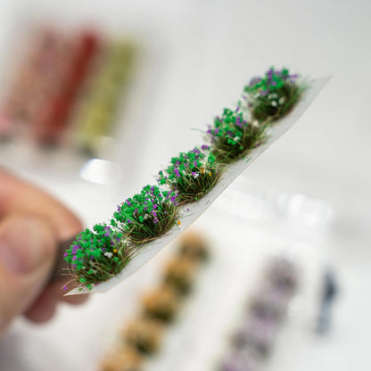 Green purple flower tuft strip with dense grass texture, miniature roadside scenery accessory for train layout diorama
