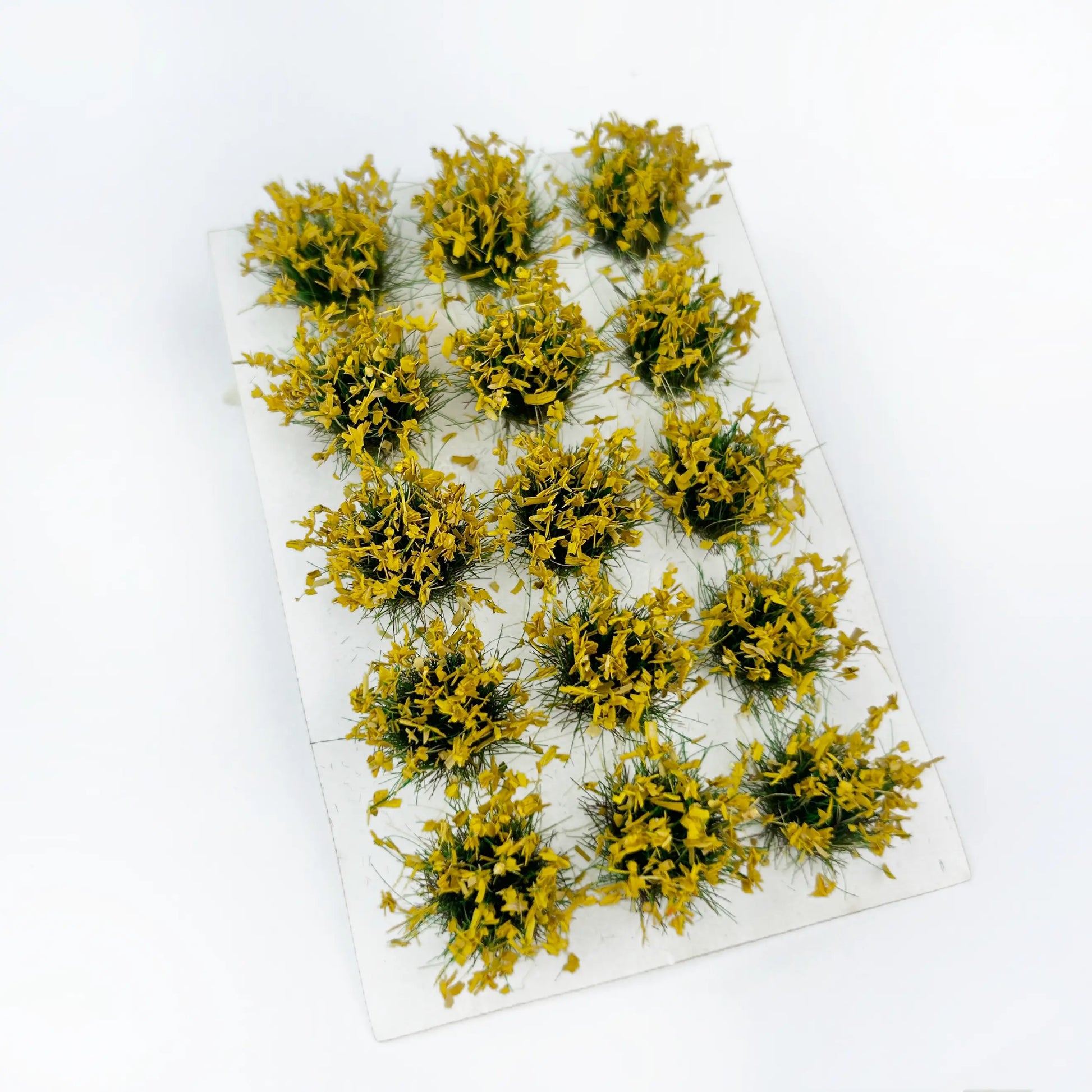 Vibrant solid yellow static grass tuft sheet, uniform warm tone miniature grass patches for autumn field diorama, warhammer terrain and architectural model decoration
