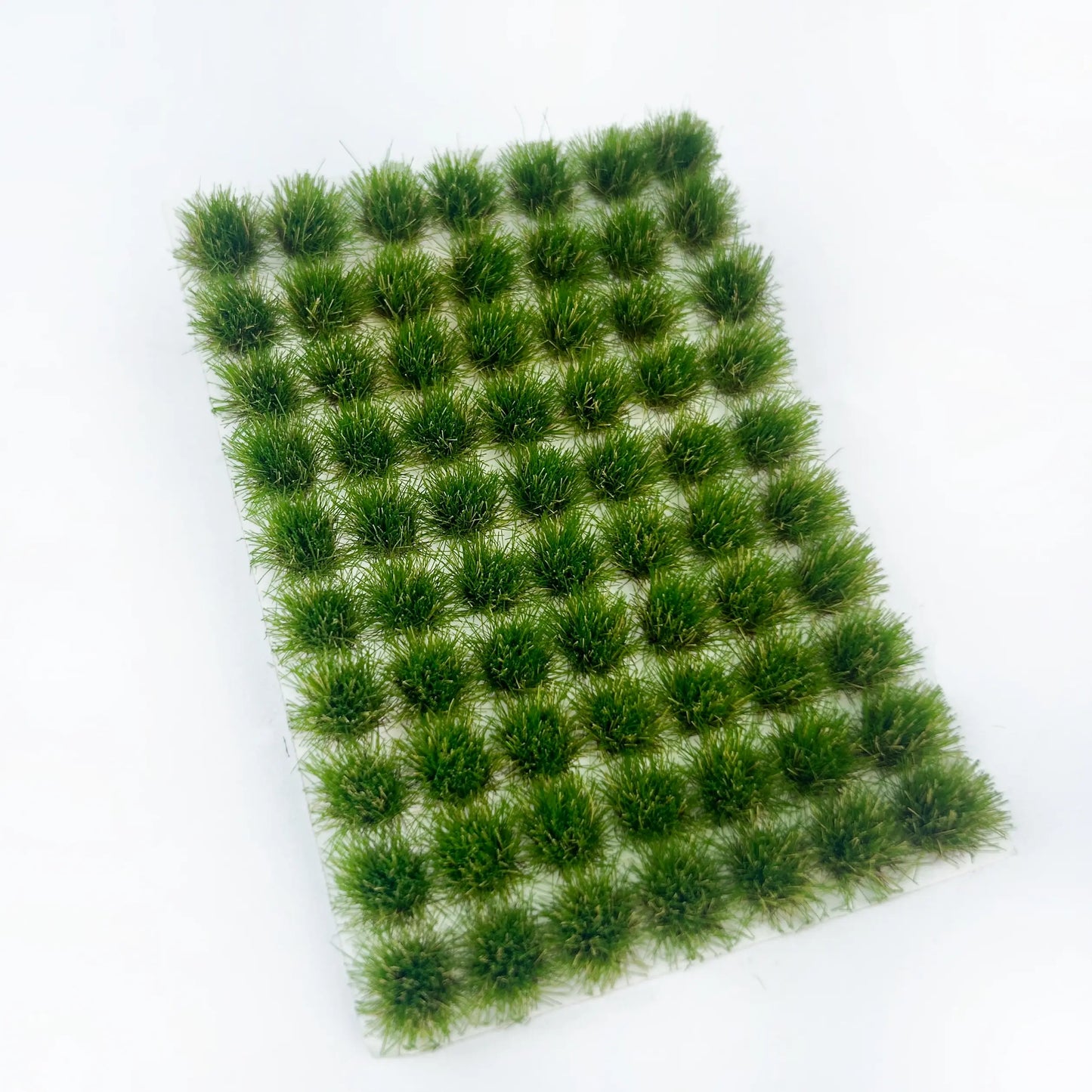 Self-adhesive layered summer green miniature grass tuft mat with full size measurements marked, for lush wild meadow diorama and tabletop wargame terrain craft reference