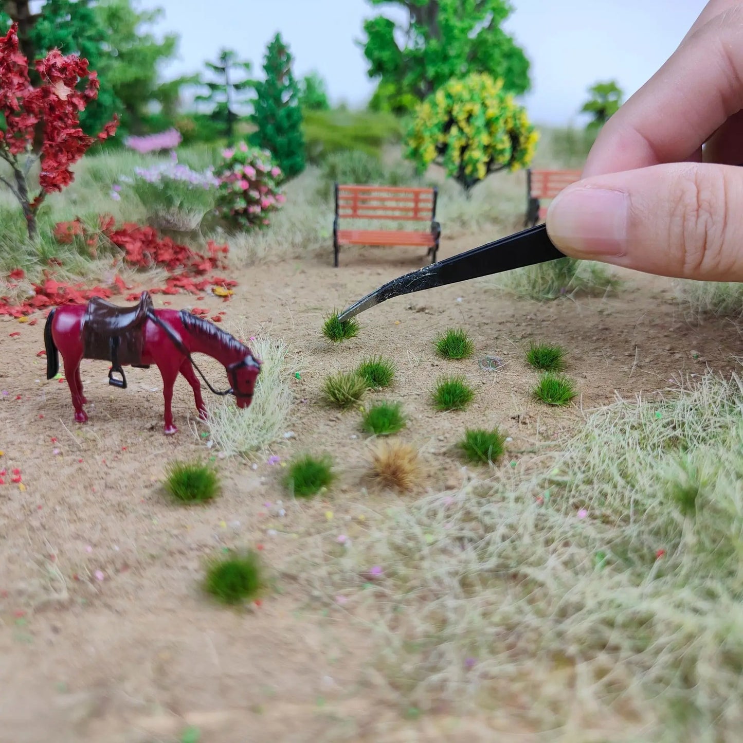 Realistic finished scale diorama landscape scene decorated with self-adhesive static grass tufts, featuring miniature horse, park benches, trees and flower clusters, scenery demo for wargame base building, static grass tufts, miniature diorama supplies, wargame terrain material, model railway grass, self-adhesive grass clusters, scale model scenery, warhammer terrain, hobby craft grass