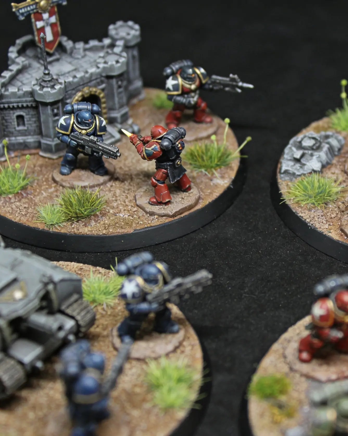 Static grass tufts used on a Warhammer miniature battlefield base with painted tabletop gaming figures and realistic terrain