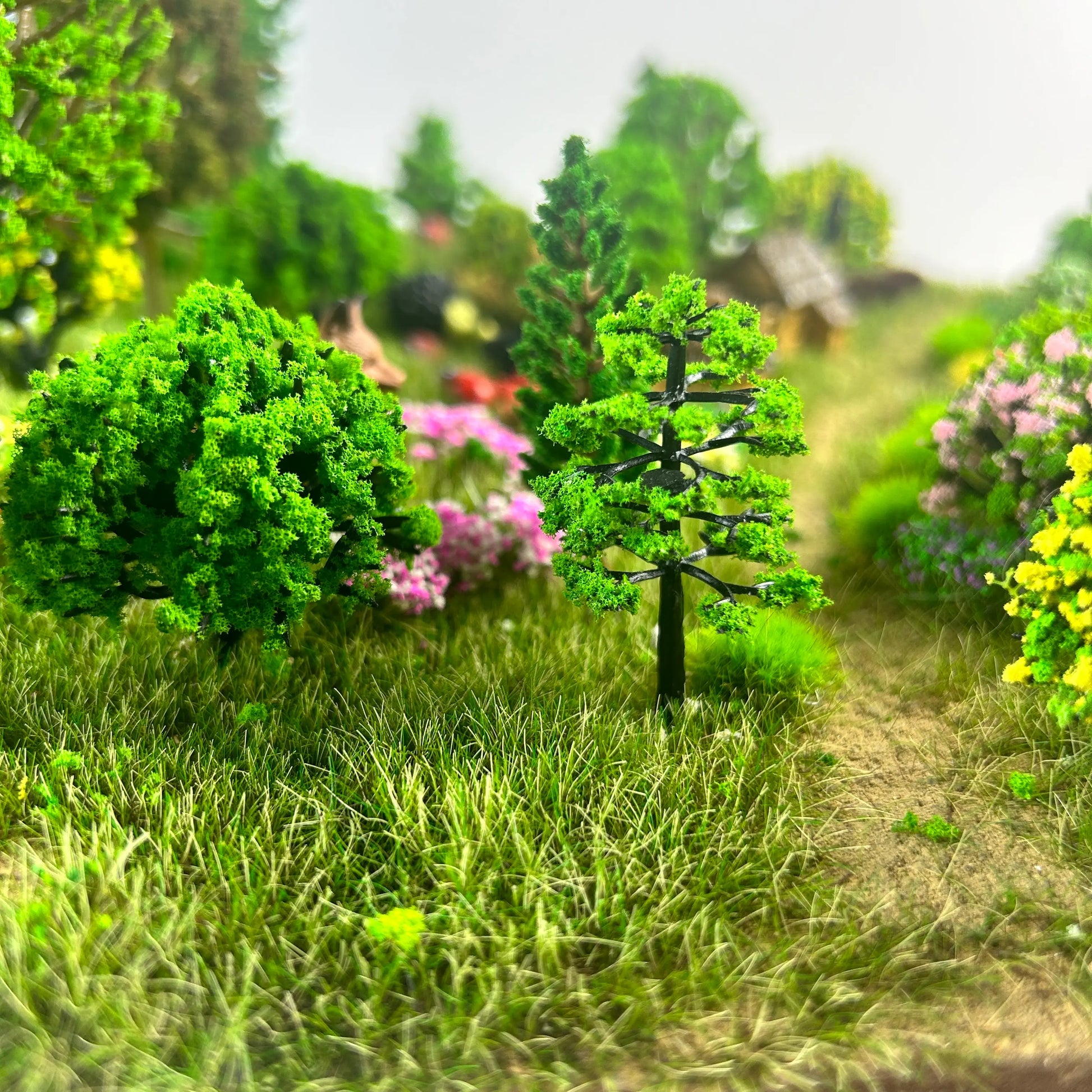 Completed 1/35 scale miniature village diorama covered with realistic static grass tufts