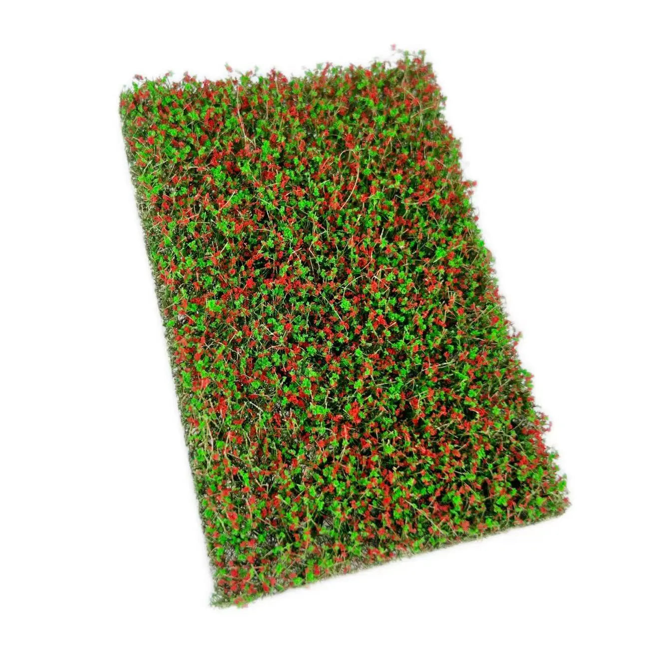 Rectangular artificial miniature grass mat filled with lush green foliage and countless tiny soft pink flowers, top full shot for DIY diorama micro landscape terrain layout