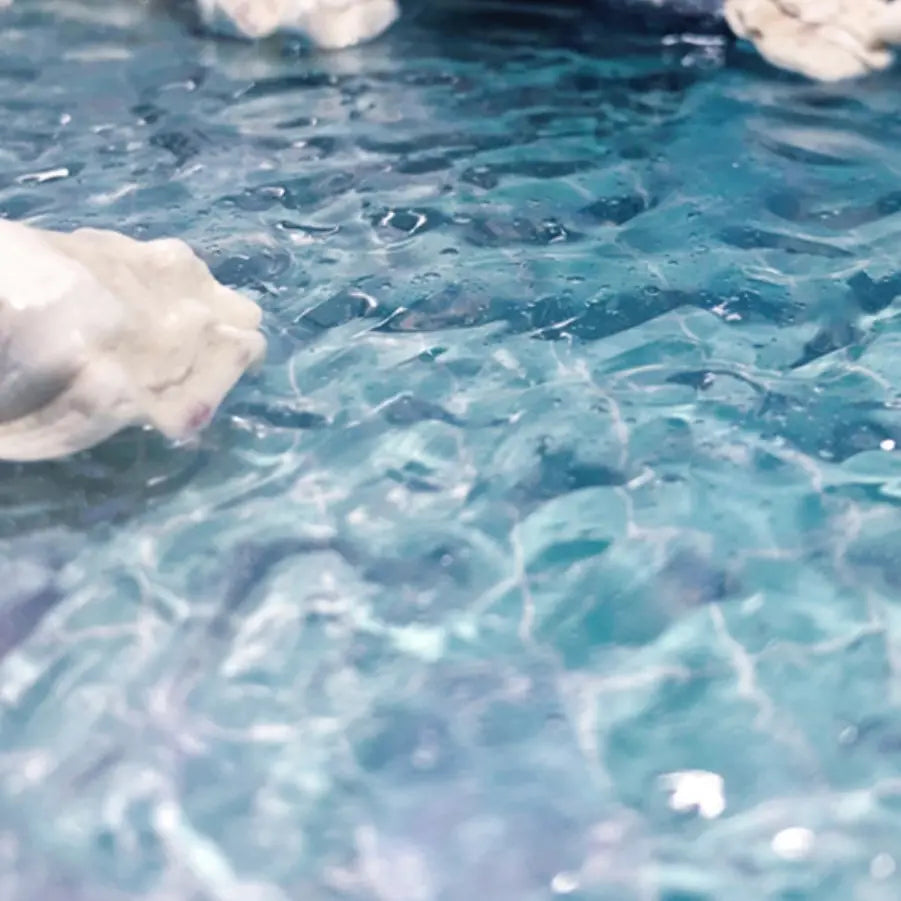 Large finished cliff seaside scale model diorama display with wide smooth ocean surface crafted from dark blue water texture paste, product showcase of waterscape gel for hobby miniature terrain making
