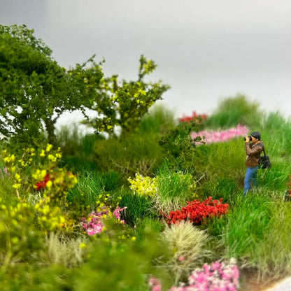 Realistic wild mountain miniature terrain diorama with photographer tiny people figure, colorful static grass and bush scenery, small human model for landscape scale model, wargame and railway layout decoration