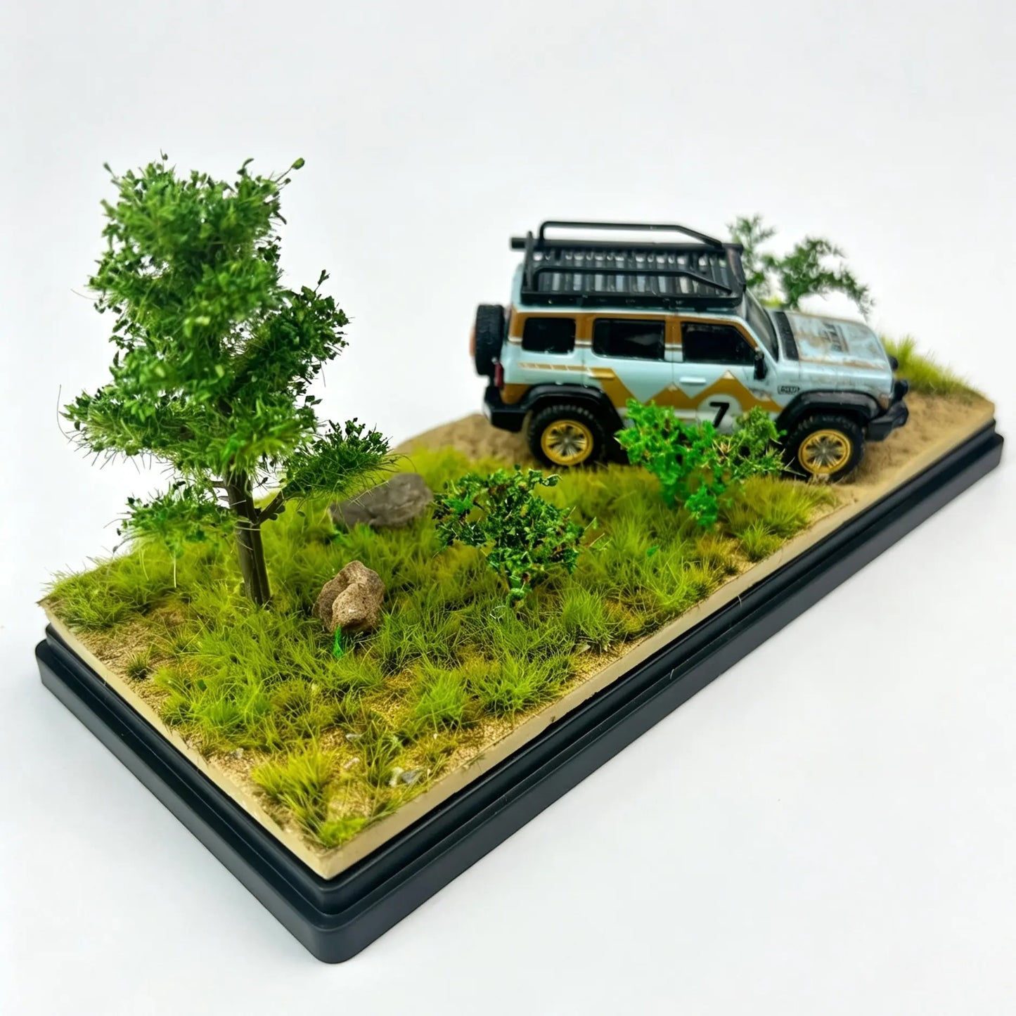Side view of spring wild forest miniature terrain base, dense bright green static grass clumps and small shrubs for 1:64 off-road car

