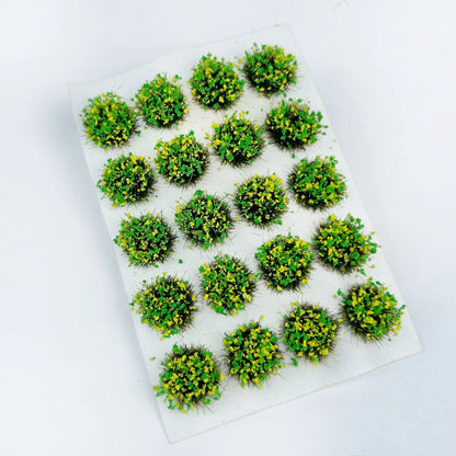 Soft light green round self-stick static grass tuft sheet filled with delicate yellow wildflower clusters, spring meadow mini grass clumps for countryside diorama layout, sci-fi & historical wargame terrain and scale train model scenery
